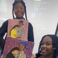 2 NIARA students holding their paintings